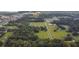 Aerial view showing property with a pond and surrounding trees at 1440 Duff Rd, Lakeland, FL 33810