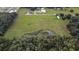 Aerial view of vacant land with pond and surrounding trees at 1440 Duff Rd, Lakeland, FL 33810