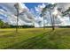 Large pasture with tall pines and a red barn in the background at 1440 Duff Rd, Lakeland, FL 33810