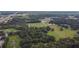 Aerial view showing property with a pond and surrounding trees at 1440 Duff Rd, Lakeland, FL 33810