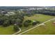 Aerial view of a property with a pond, home, and surrounding fields at 1440 Duff Rd, Lakeland, FL 33810