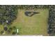 Aerial view showing property with a pond and surrounding trees at 1440 Duff Rd, Lakeland, FL 33810