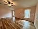 Bright bedroom with wood-look flooring and ceiling fan at 819 Ariana St, Lakeland, FL 33803