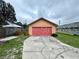 Detached garage with red door and ample space at 819 Ariana St, Lakeland, FL 33803