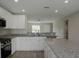 White shaker cabinets, granite countertops and stainless steel appliances at 1138 Avenue E, Haines City, FL 33844