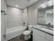 Bathroom with granite vanity and gray tile shower at 1138 Avenue E, Haines City, FL 33844