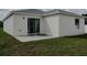 Newly constructed home with a white exterior and a patio at 1138 Avenue E, Haines City, FL 33844