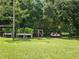 Lush backyard with a chicken coop, raised garden beds, and a swing at 4810 N Galloway Rd, Lakeland, FL 33810
