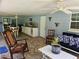 Covered patio with outdoor kitchen, seating area, and lush landscaping at 4810 N Galloway Rd, Lakeland, FL 33810