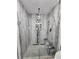 Walk-in shower with glass doors, built-in bench, and tile walls at 4810 N Galloway Rd, Lakeland, FL 33810