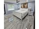 Spacious Primary bedroom with large bed, elegant furnishings, and stylish tile floor at 4810 N Galloway Rd, Lakeland, FL 33810
