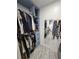 Large closet with hanging clothes, built-in drawers, and full-length mirror at 4810 N Galloway Rd, Lakeland, FL 33810