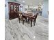 Dining room with wooden table, china cabinet, and marble-look tile flooring at 4810 N Galloway Rd, Lakeland, FL 33810