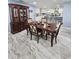 Dining room with elegant wooden table, china cabinet, and marble-look tile at 4810 N Galloway Rd, Lakeland, FL 33810