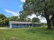 Single-story blue home with attached garage and large oak tree at 4810 N Galloway Rd, Lakeland, FL 33810