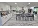 Modern kitchen with white shaker cabinets, stainless steel appliances, and a large island at 4810 N Galloway Rd, Lakeland, FL 33810