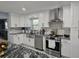 Updated kitchen with white cabinetry, stainless steel appliances, and a stylish backsplash at 4810 N Galloway Rd, Lakeland, FL 33810