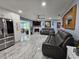 Living room with a fireplace, leather furniture, and an open view to the kitchen at 4810 N Galloway Rd, Lakeland, FL 33810