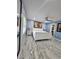 Spacious main bedroom with white bed, artwork, ceiling fan, and walk-in closet access at 4810 N Galloway Rd, Lakeland, FL 33810
