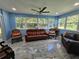 Bright and airy sunroom with large windows, comfortable seating, and tile flooring at 4810 N Galloway Rd, Lakeland, FL 33810