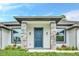 Modern front entrance with stone accents and a dark blue door at 19073 Sabal St, Orlando, FL 32833