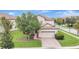 Two-story house with attached garage, landscaping, and brick driveway at 9151 Wedge Dr, Davenport, FL 33896