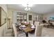 Bright dining room with a wooden table and wicker chairs, adjacent to the kitchen and living room at 9151 Wedge Dr, Davenport, FL 33896