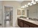 Double vanity bathroom with granite countertops and access to the shower at 9151 Wedge Dr, Davenport, FL 33896