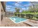 Inviting screened pool and spa with ample lounge space at 9151 Wedge Dr, Davenport, FL 33896