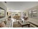Spacious living room with a comfortable sofa and access to the dining room and kitchen at 9151 Wedge Dr, Davenport, FL 33896