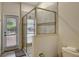 Bathroom with a walk-in shower and door to the backyard at 9151 Wedge Dr, Davenport, FL 33896