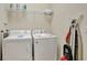 Convenient laundry room with washer, dryer, and ironing board at 9151 Wedge Dr, Davenport, FL 33896