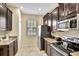 L-shaped kitchen with stainless steel appliances and granite countertops at 9151 Wedge Dr, Davenport, FL 33896