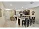Modern kitchen with dark cabinets, breakfast bar and stainless steel appliances at 9151 Wedge Dr, Davenport, FL 33896