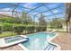 Relaxing screened pool and spa with comfortable seating at 9151 Wedge Dr, Davenport, FL 33896