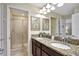 Double vanity bathroom with granite countertop and shower at 9151 Wedge Dr, Davenport, FL 33896