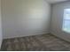 Bedroom with neutral carpeting and large window at 4415 Casey Ct, The Villages, FL 32163