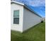 Side view of a house with vinyl siding and window at 4415 Casey Ct, The Villages, FL 32163