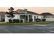 White house with gray roof, screened porch, and well-manicured lawn at 4415 Casey Ct, The Villages, FL 32163