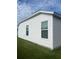 Side view of a house with vinyl siding and window at 4415 Casey Ct, The Villages, FL 32163