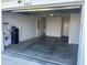 Large garage with concrete floor and extra storage at 4415 Casey Ct, The Villages, FL 32163
