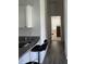 Hallway with wood-look floors leading to a bedroom at 4415 Casey Ct, The Villages, FL 32163
