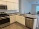 Open kitchen with stainless steel dishwasher and ample counter space at 4415 Casey Ct, The Villages, FL 32163