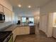 Kitchen features stainless steel appliances and views to living room at 4415 Casey Ct, The Villages, FL 32163