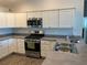 Modern kitchen with stainless steel range and double sink at 4415 Casey Ct, The Villages, FL 32163