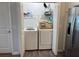 Washer and dryer in a well-lit laundry closet at 4415 Casey Ct, The Villages, FL 32163
