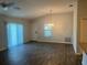 Bright living room with wood-look floors and ceiling fan at 4415 Casey Ct, The Villages, FL 32163