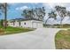 Two-car garage and waterfront property with a paved driveway at 225 Diesel Rd, Mulberry, FL 33860