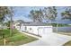 House exterior with a two car garage and waterfront view at 225 Diesel Rd, Mulberry, FL 33860