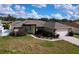 House exterior features a teal door and attached garage at 5836 Daughtery Downs Loop, Lakeland, FL 33809